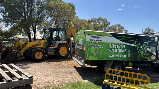Mobile hydraulic repairs — VMECH truck servicing a backhoe on a Sunshine Coast property