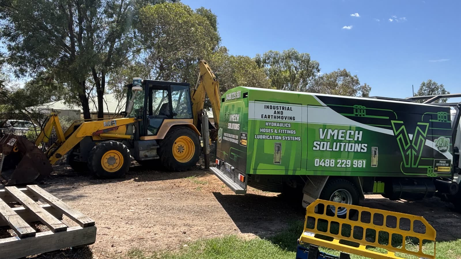Mobile hydraulic repairs — VMECH truck servicing a backhoe on a Sunshine Coast property