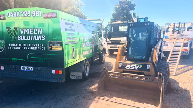 VMECH truck alongside an ASV posi-track on a job site