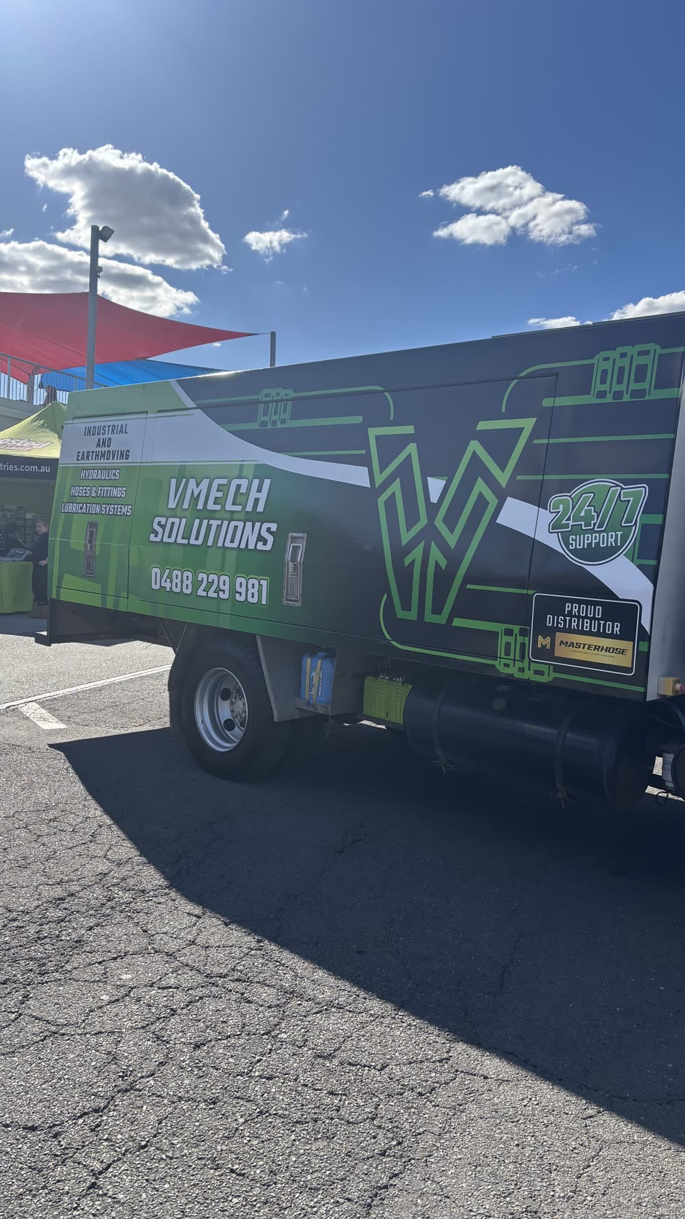 The VMECH truck parked up at a car event under shade sails